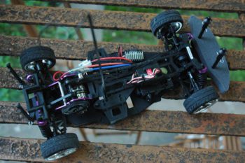 RC car with no body on top of a rusty chair