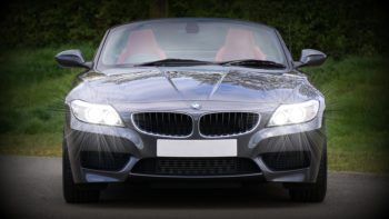 A back BMW with headlights on
