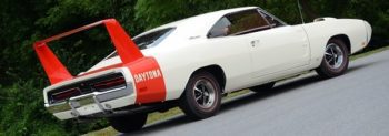 A white muscle car with a red spoiler