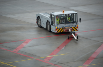 Two crew riding in an airplane tug