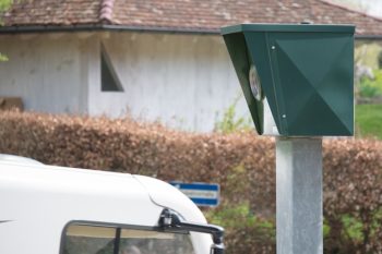 Black radar detector above the roof of a white truck